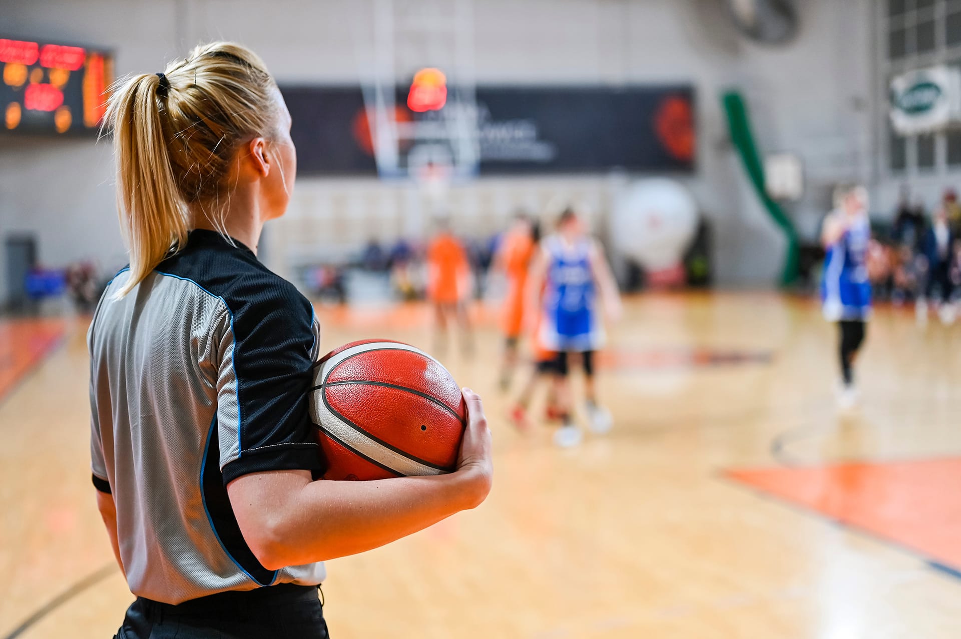 Woman,Referee,Keeps,The,Ball,During,Basketball,Match.